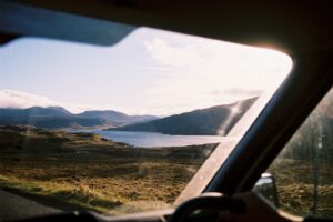 Window shot from van driving past Loch Assynt, Scottish Highlands