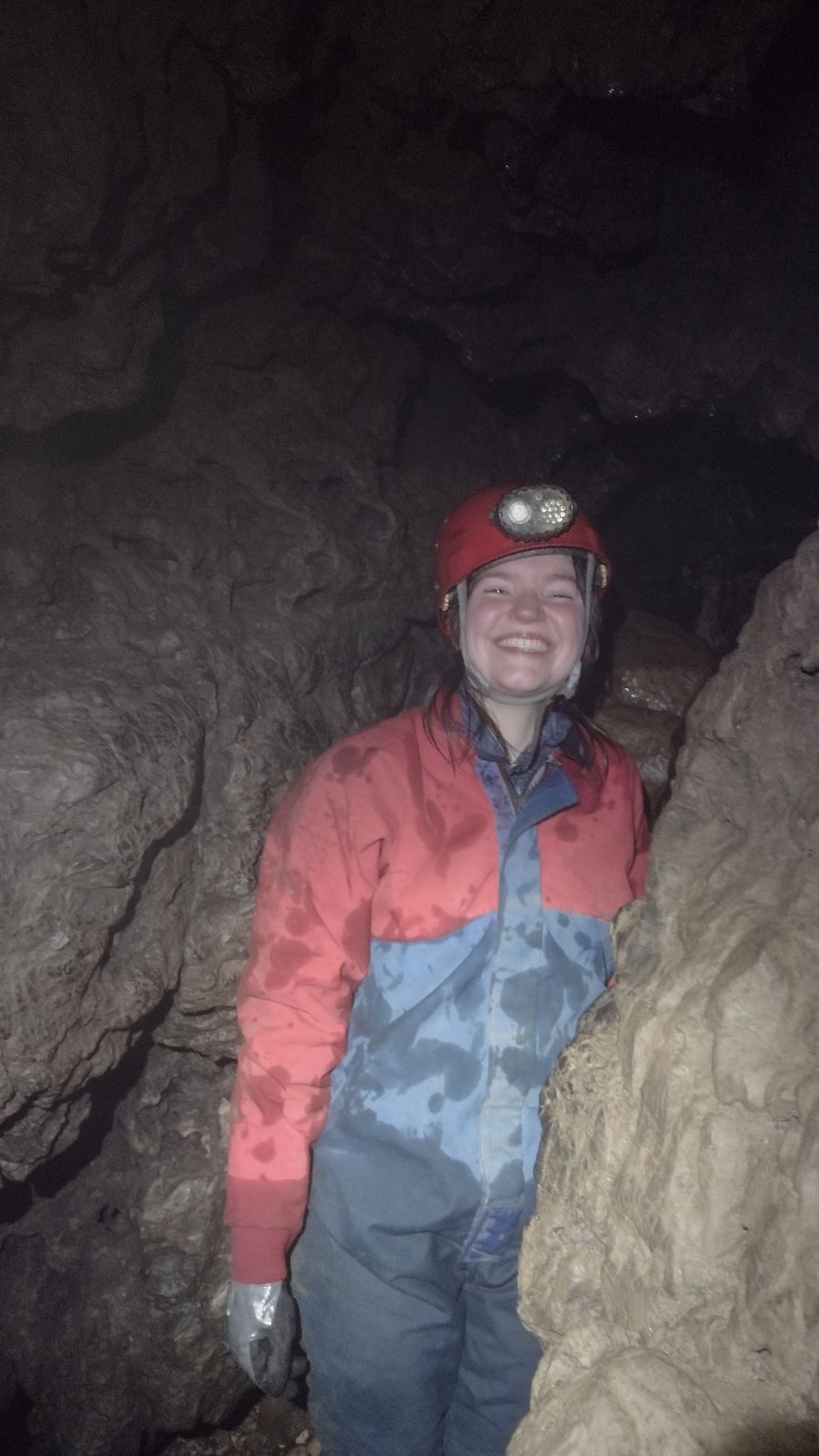 A caver in Allt nan Uamh Stream Cave, Assynt