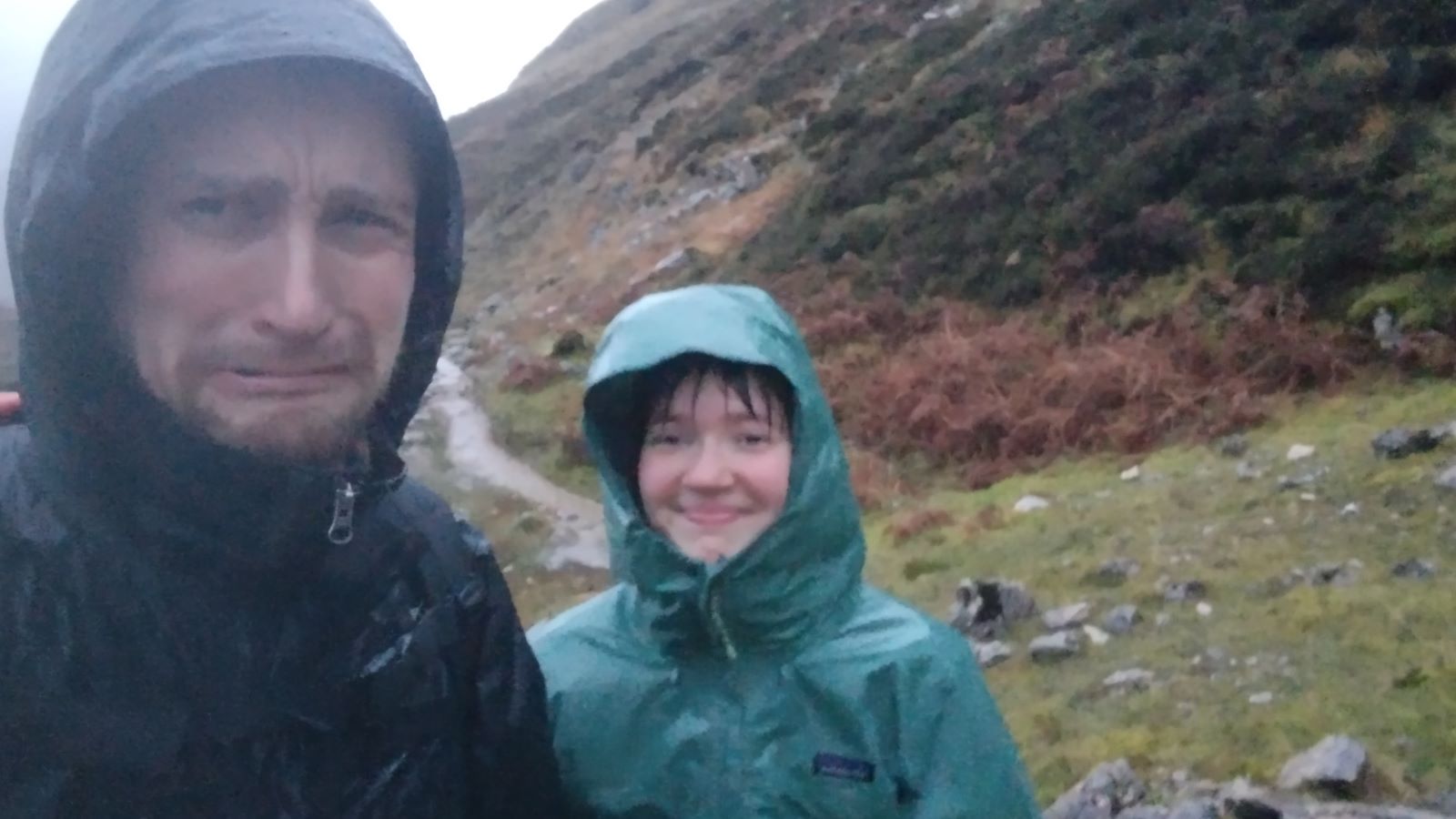 Selfie of two individuals walking through a storm in Allt nan Uamh glen, Assynt