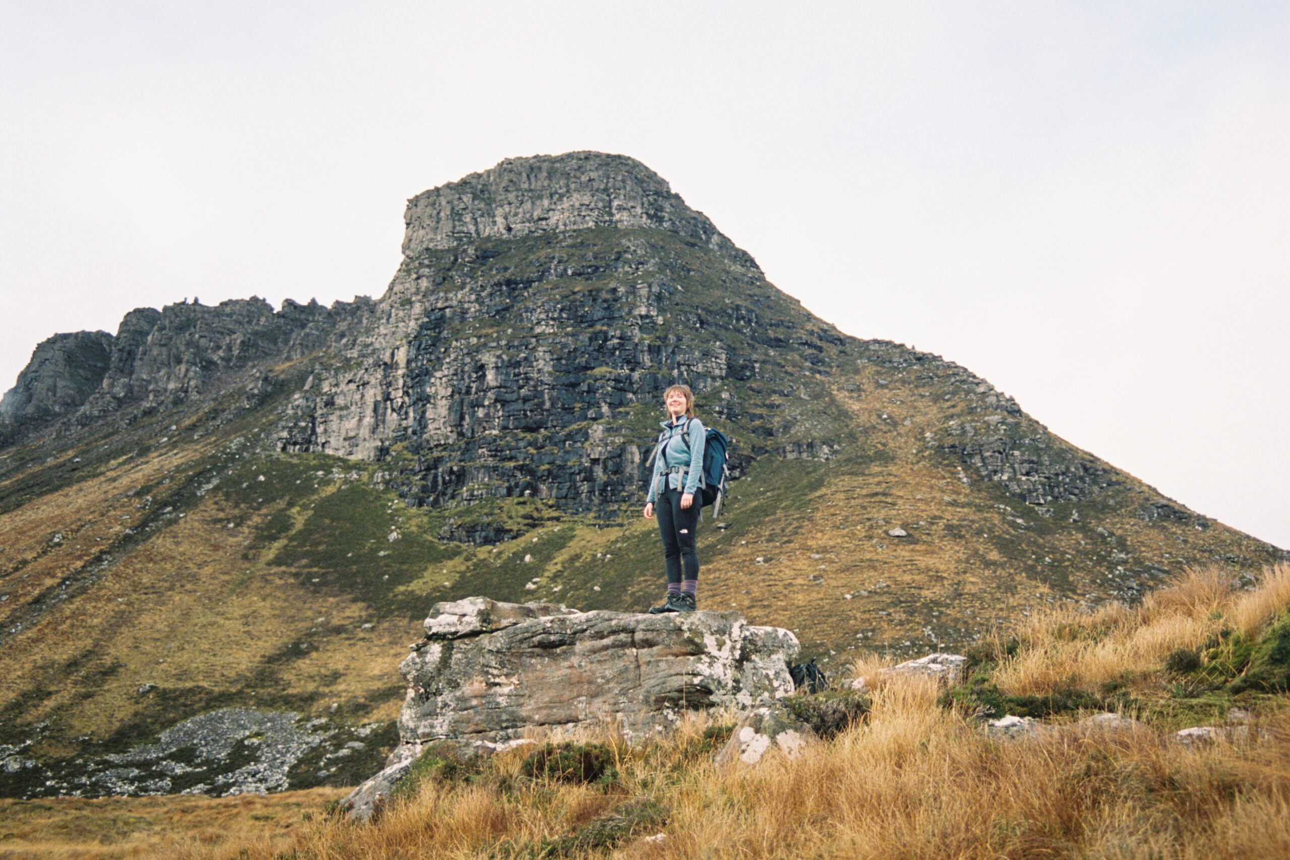 Woman standing in front of Stac Pollaidh, Assynt, Scotland