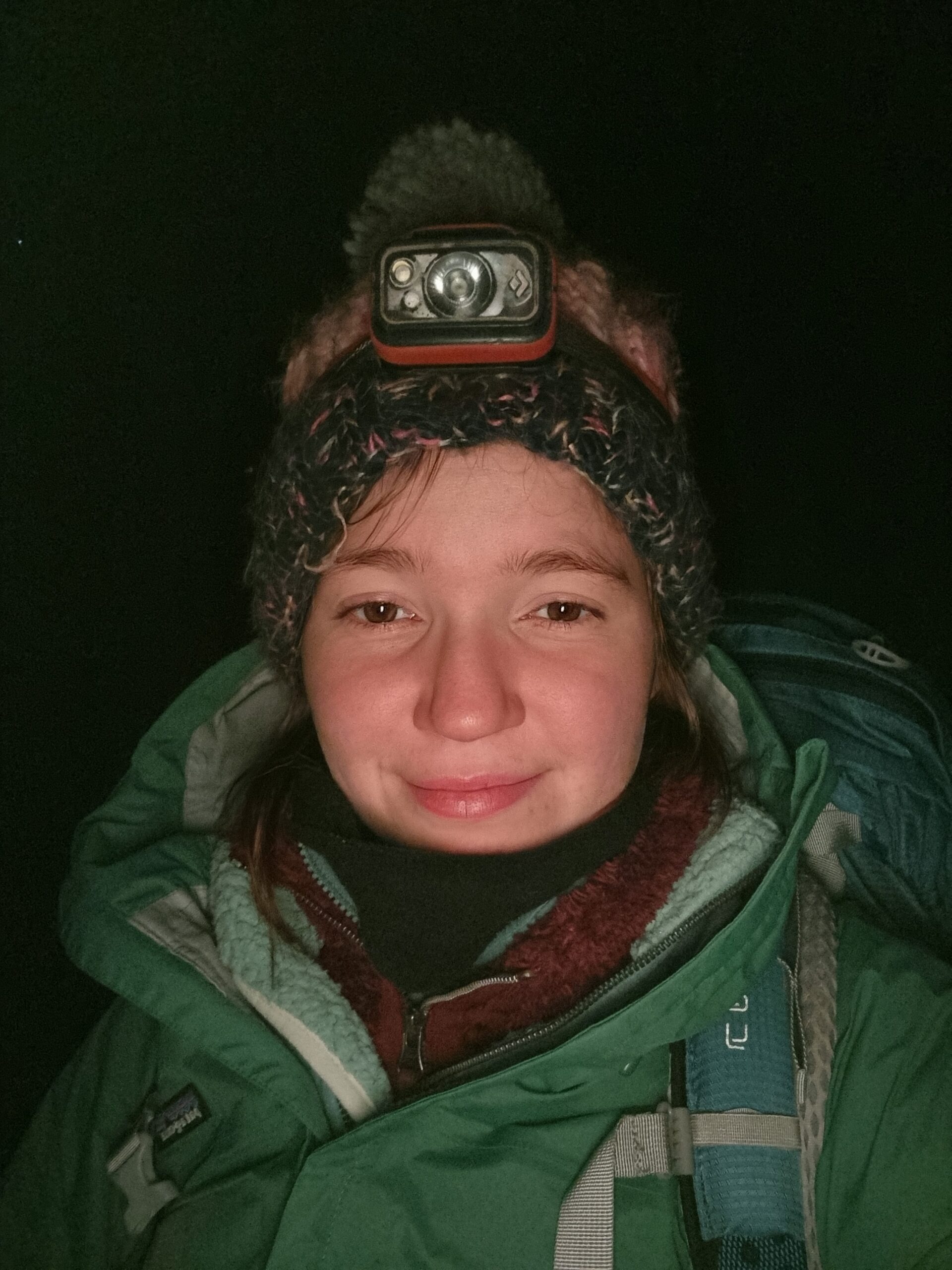 Selfie of a woman in night hiking gear