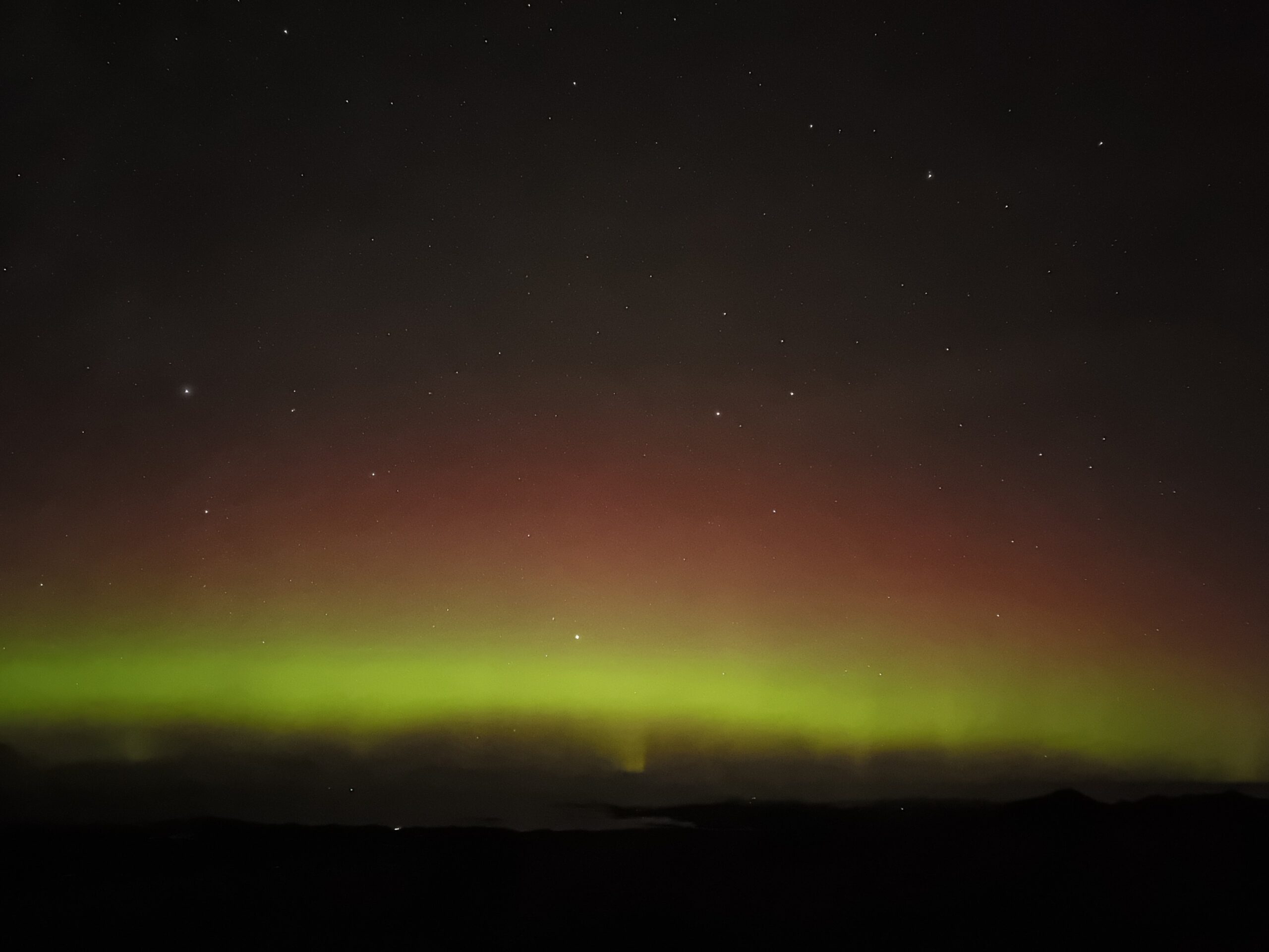Northern lights and starry sky from the summit of Suilven, Assynt, Scotland
