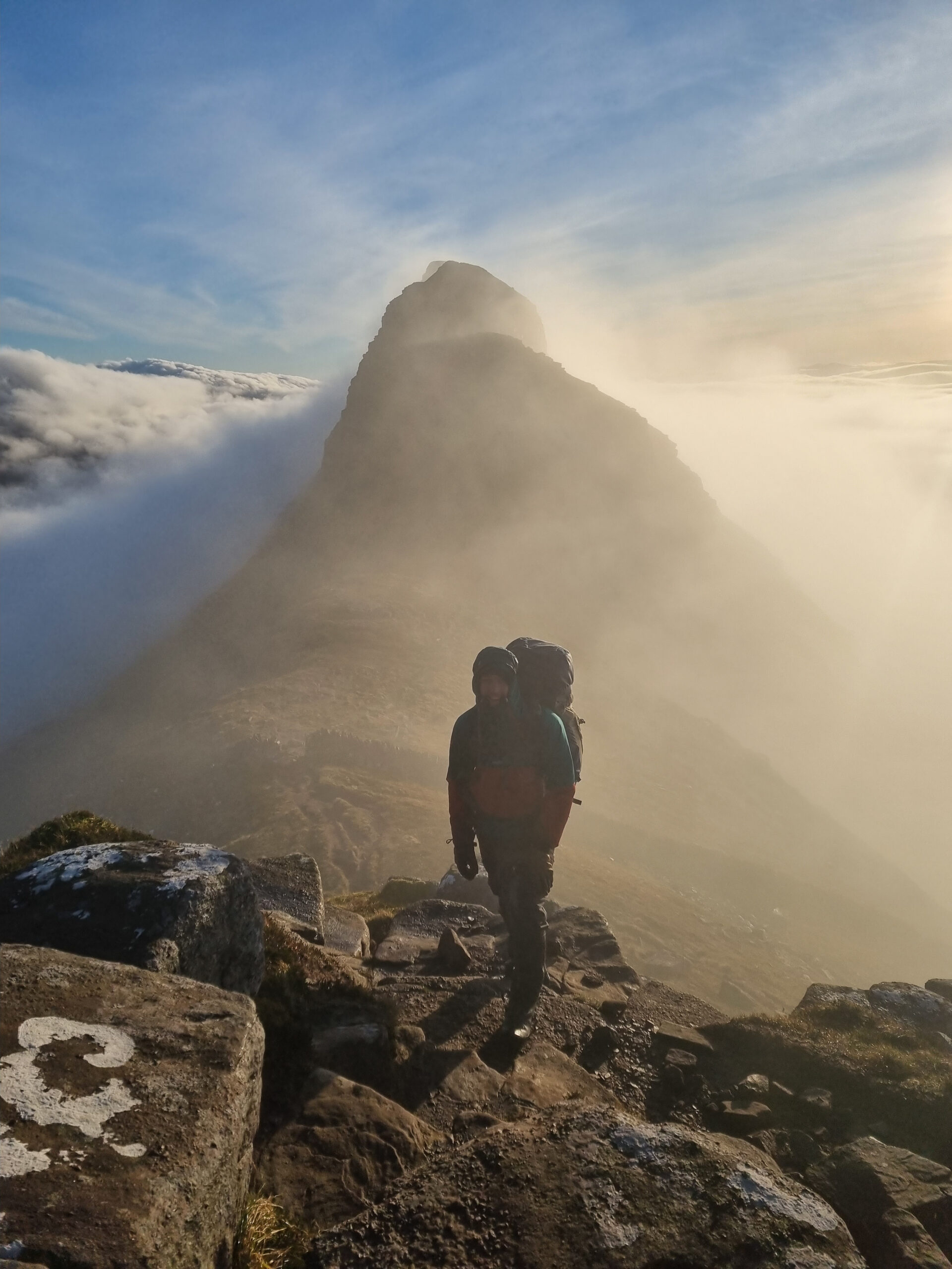 A person standing in front of Meall Meadhonach, on the ridge of Suilven, Scotland