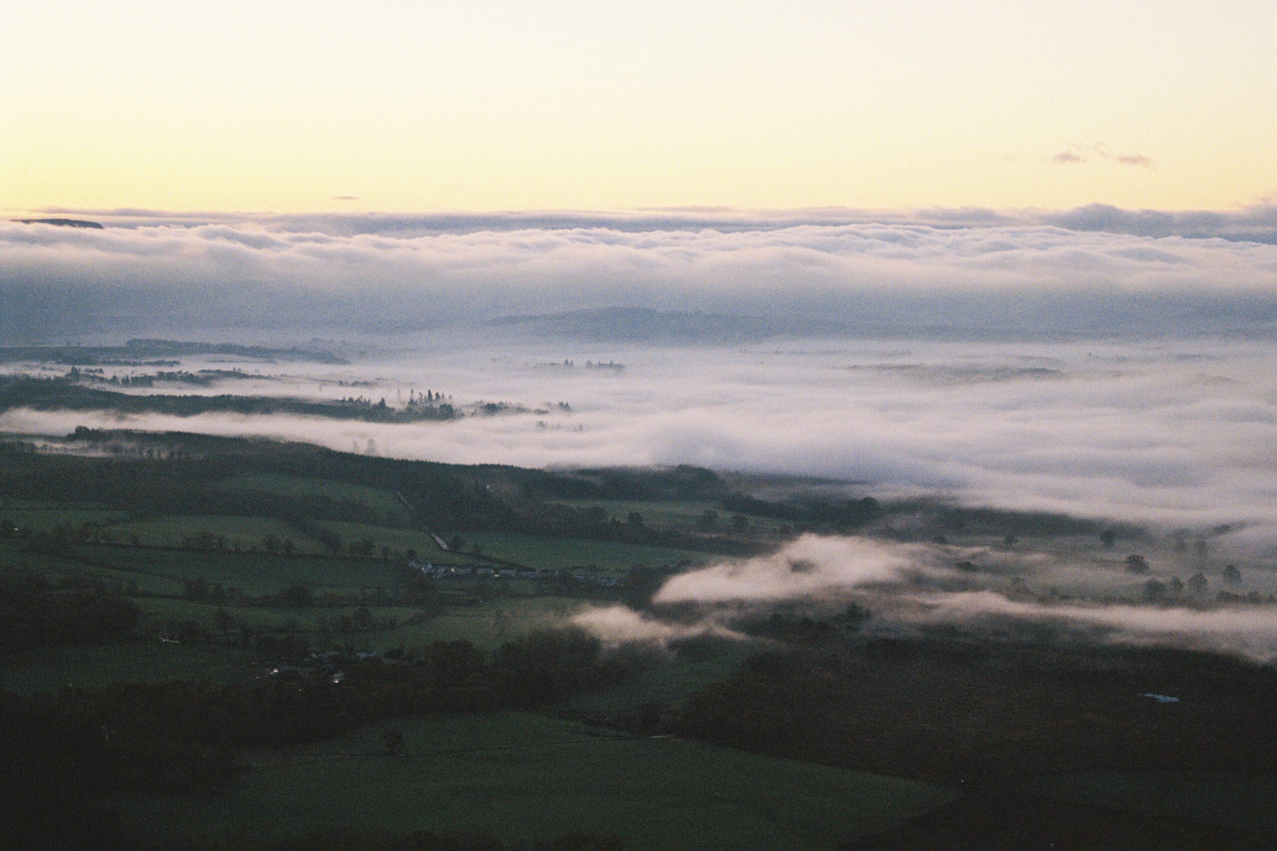 Sunrise and cloud inversion over Scottish meadows