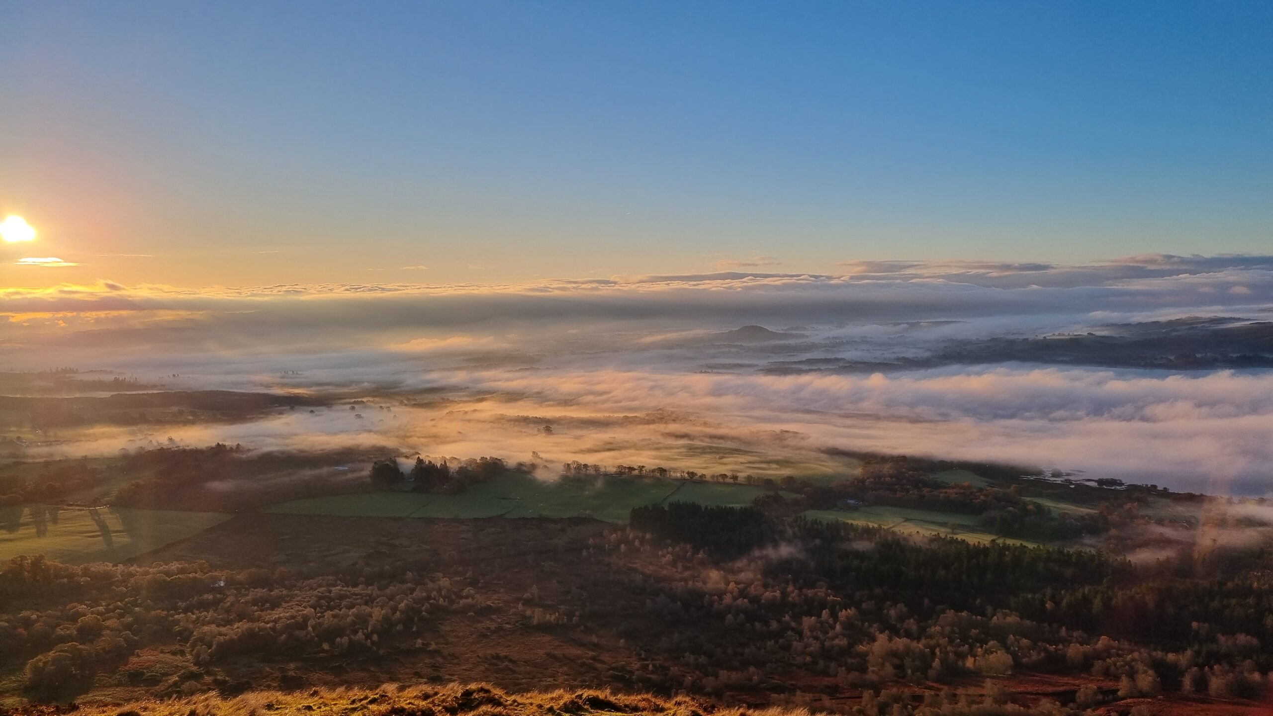 Sunrise and cloud inversion over the Scottish Lowlands from Conic Hill